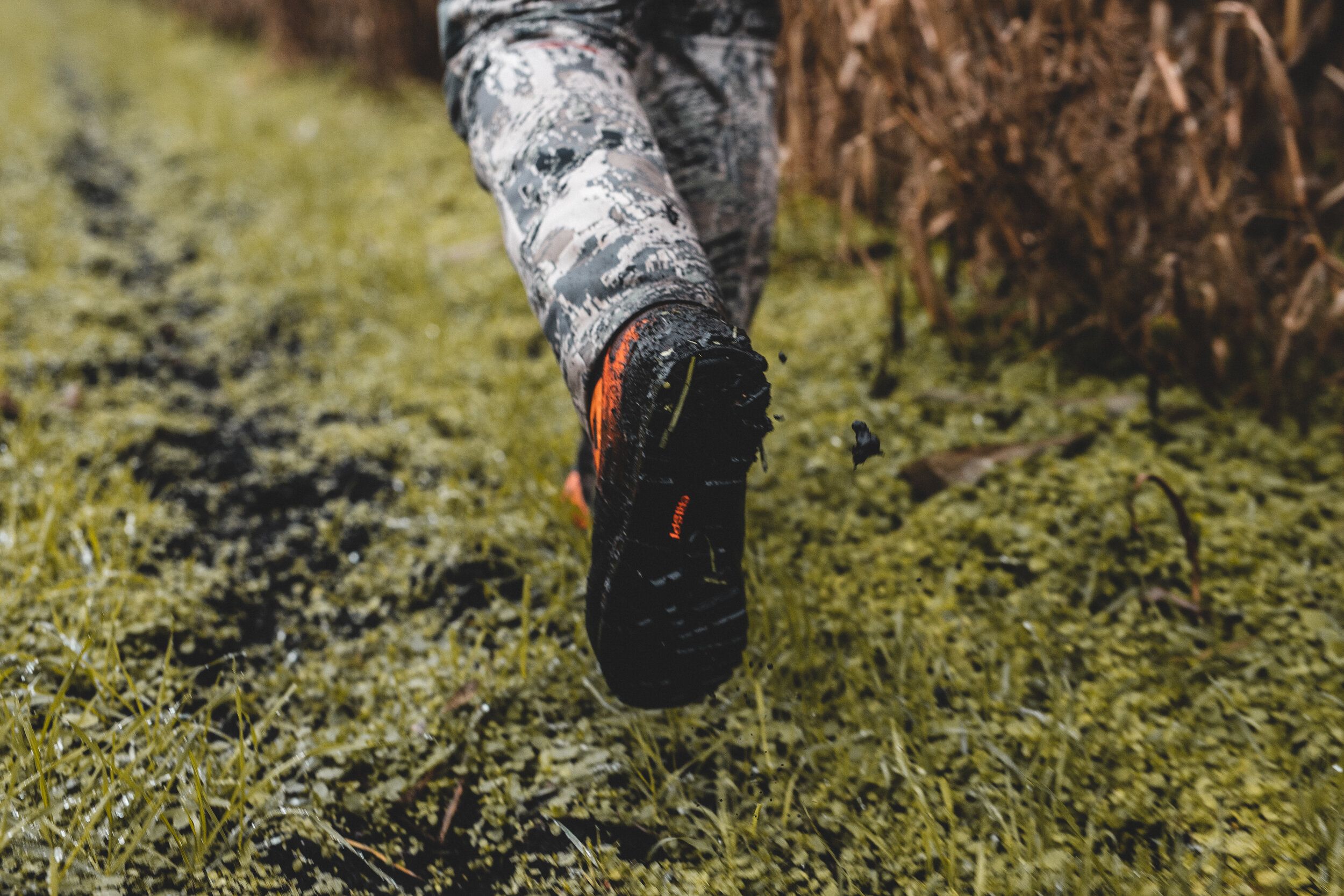 A hunter's boot on the ground as he walks, hunting in the wind concept. 