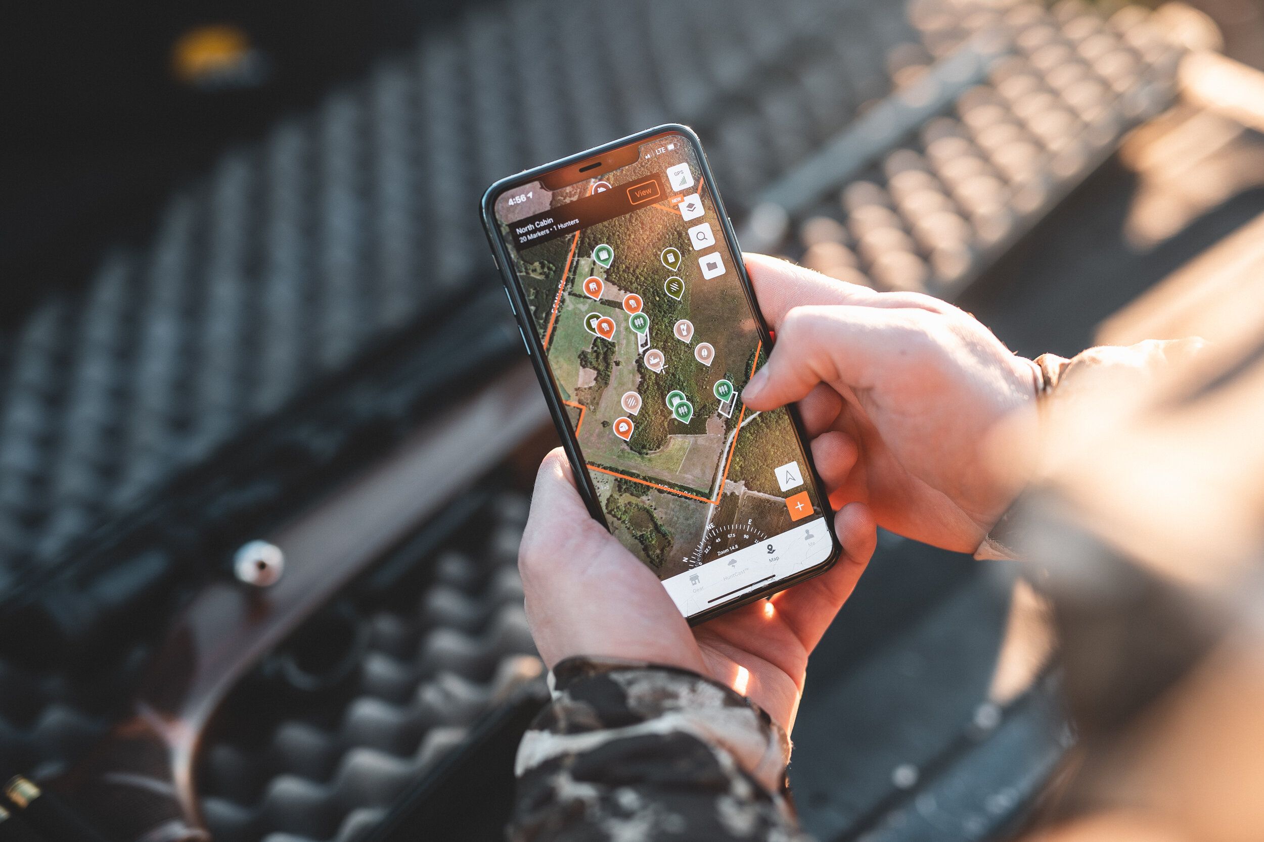 A hunter uses the HuntWise app, how to scout deer land concept. 