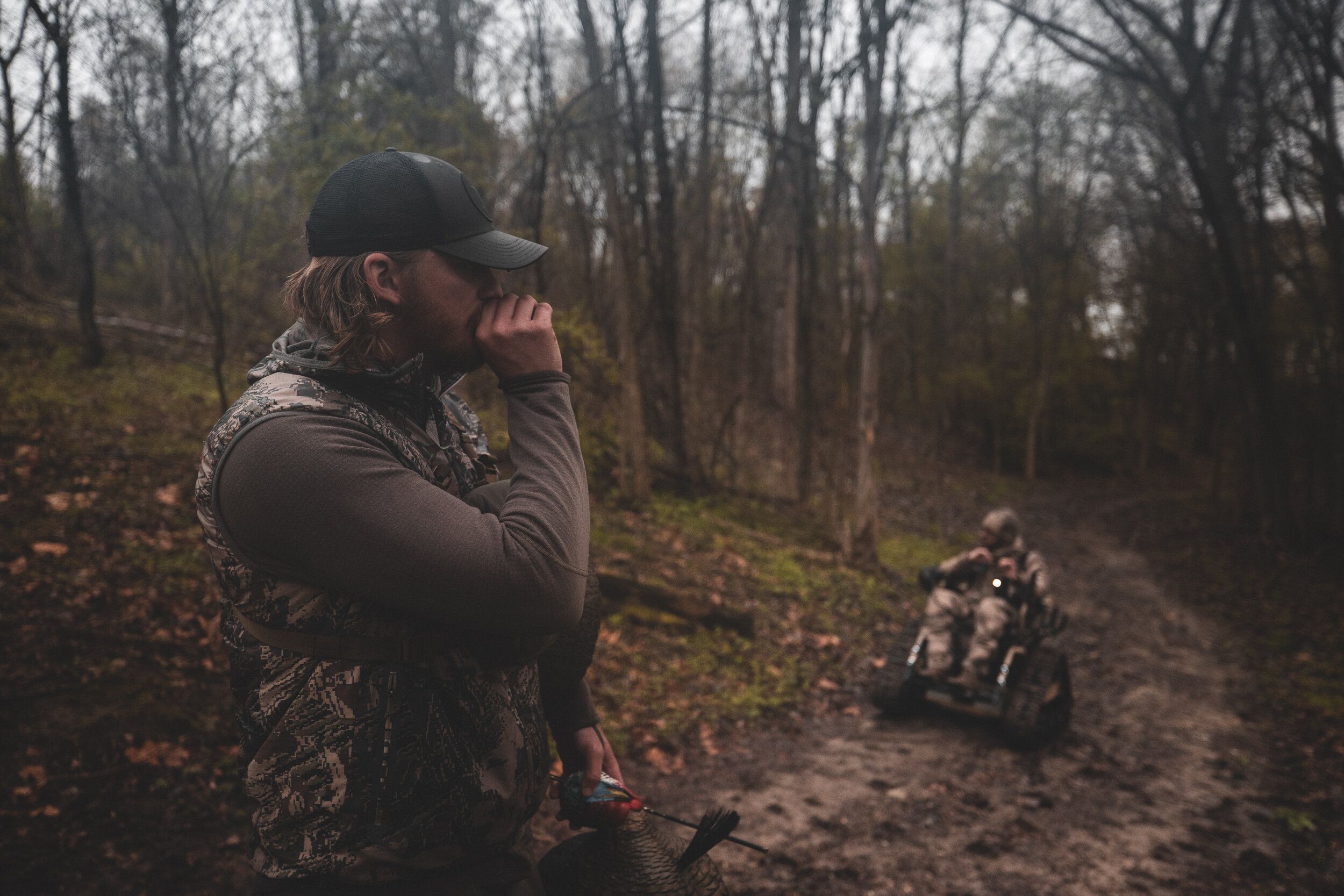 A hunter uses a turkey call, turkey hunting concept. 