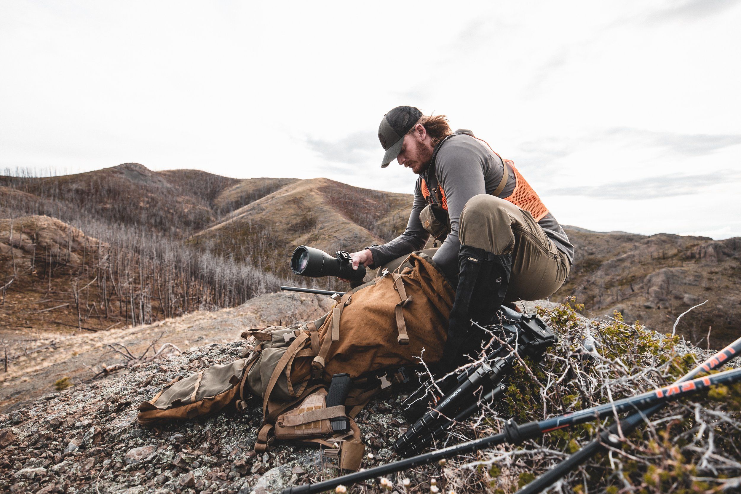 A hunter packs a scope ini a backpack, western hunting tips concept. 