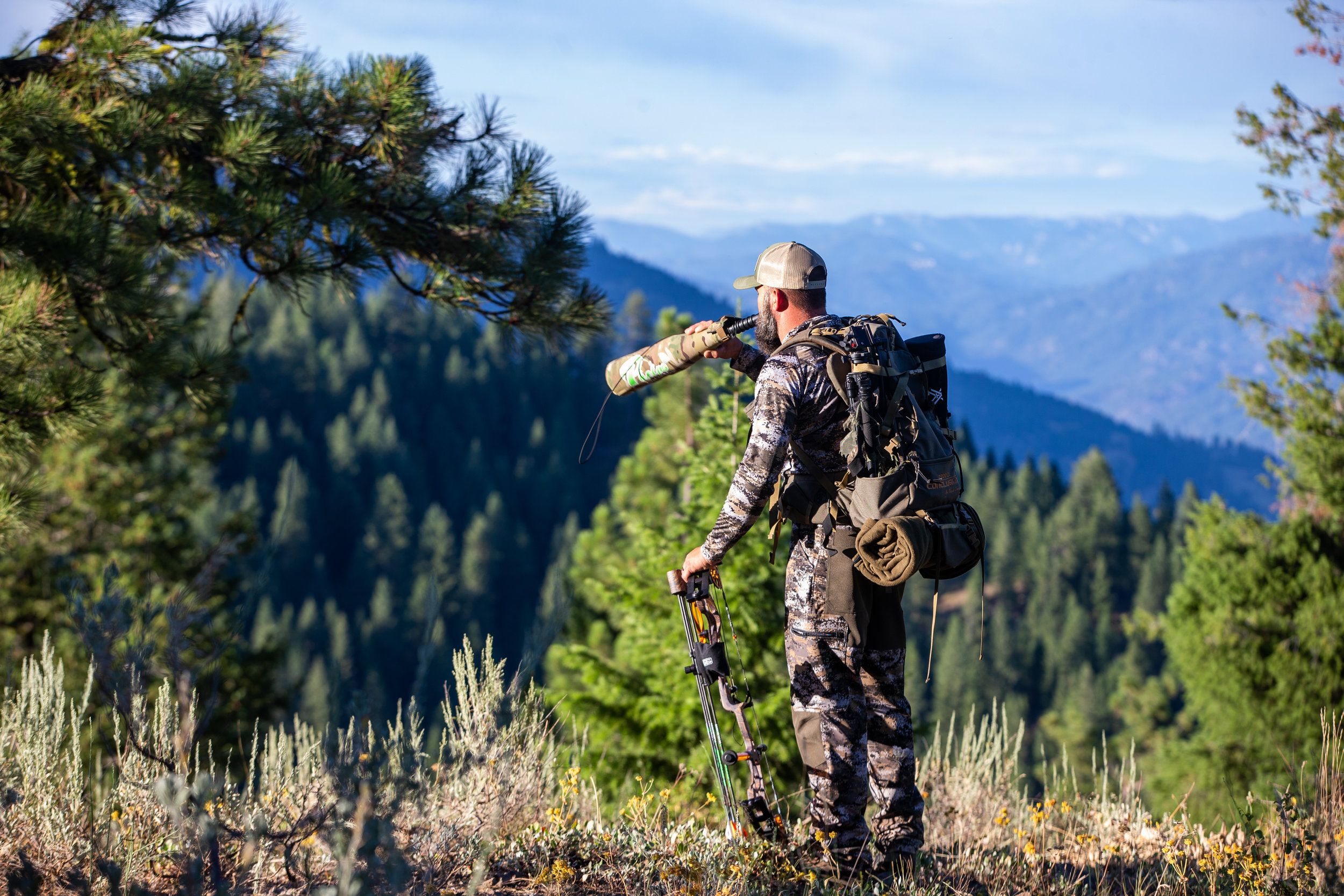 A hunter uses an elk call, elk facts concept. 