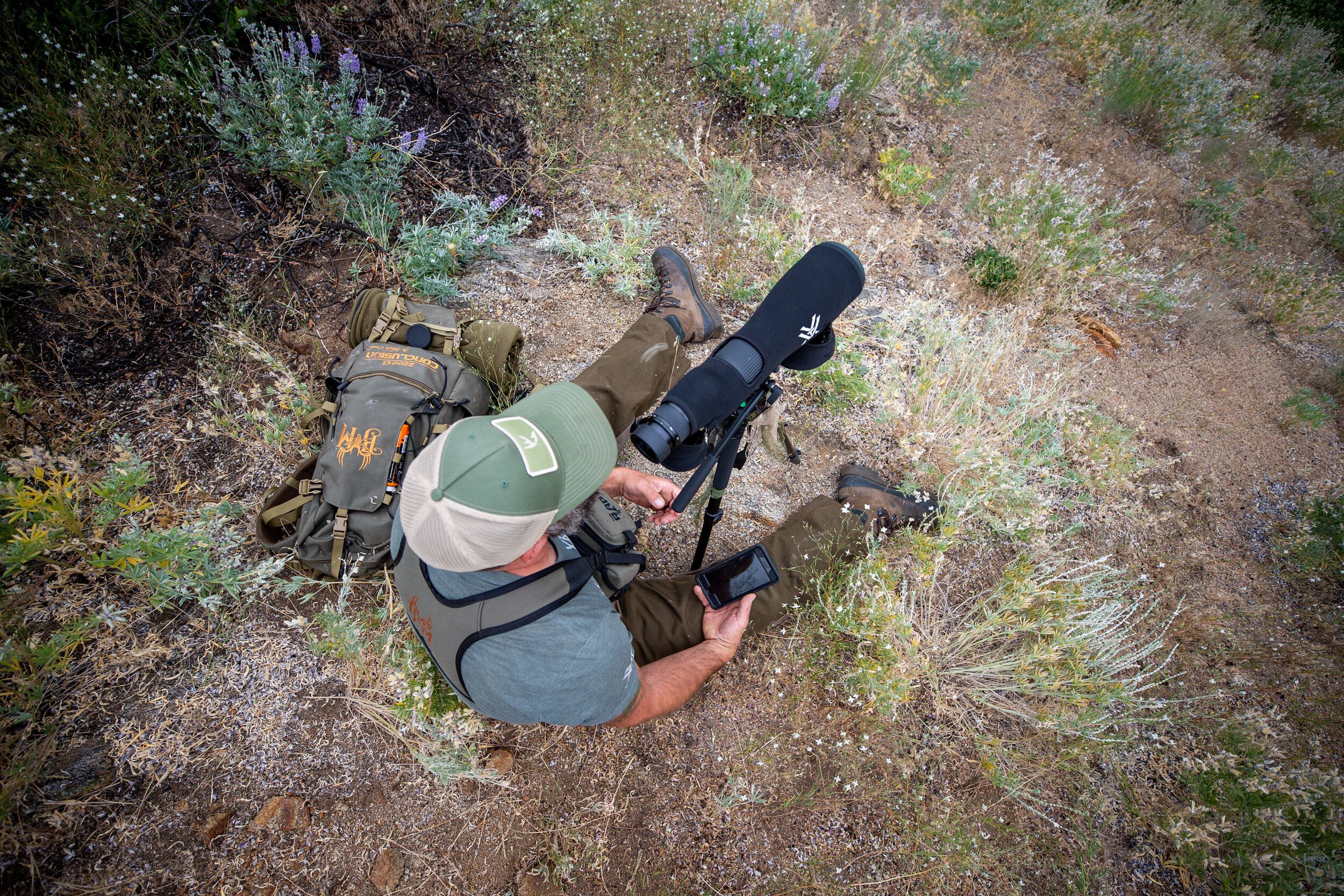 A hunter uses a scope, elk hunting concept. 