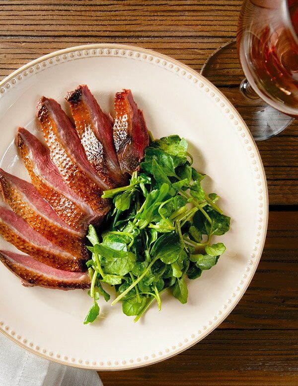 Smoked duck on a plate, wild game dishes concept. 